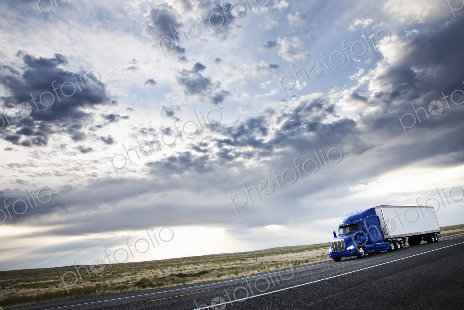 Commercial truck driving through the high desert country of eastern Washington, USA
