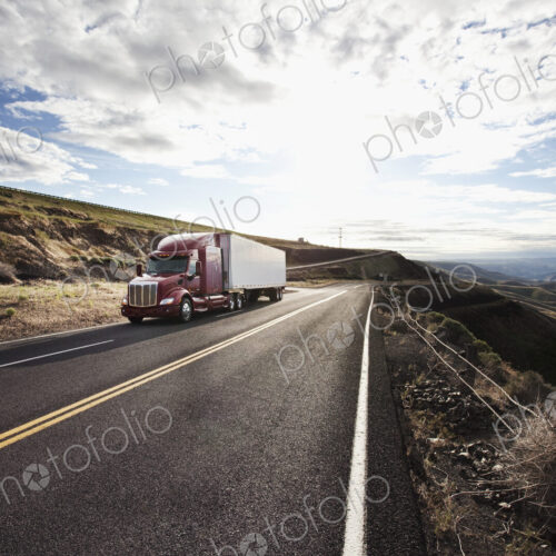 Commercial truck driving through the high desert country of eastern Washington, USA
