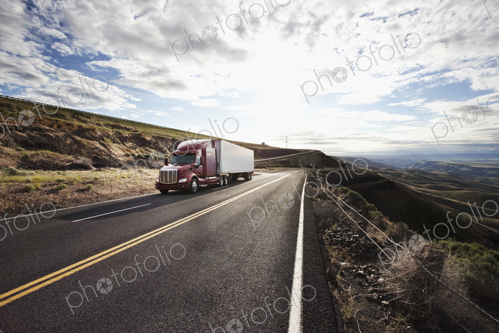 Commercial truck driving through the high desert country of eastern Washington, USA