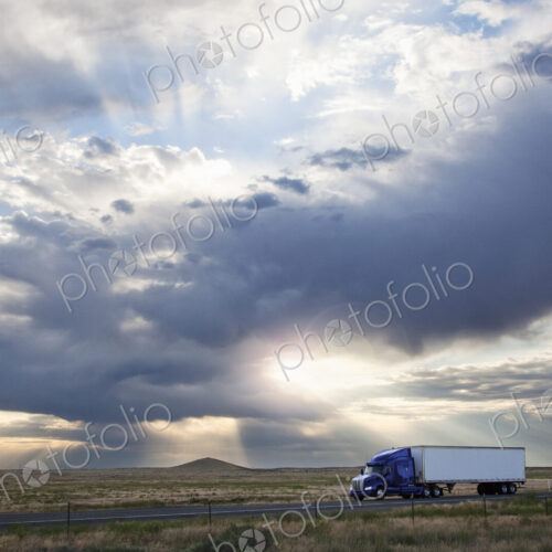 Commercial truck driving through the high desert country of eastern Washington, USA Commercial truck driving through the high desert country of eastern Washington, USA