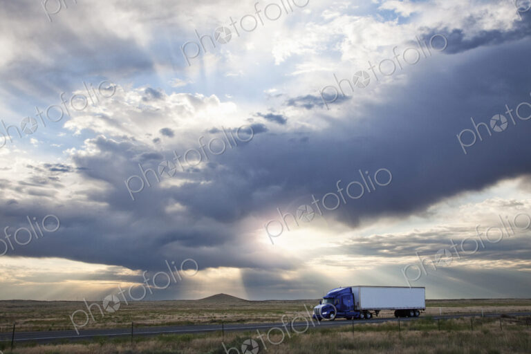 Commercial truck driving through the high desert country of eastern Washington, USA