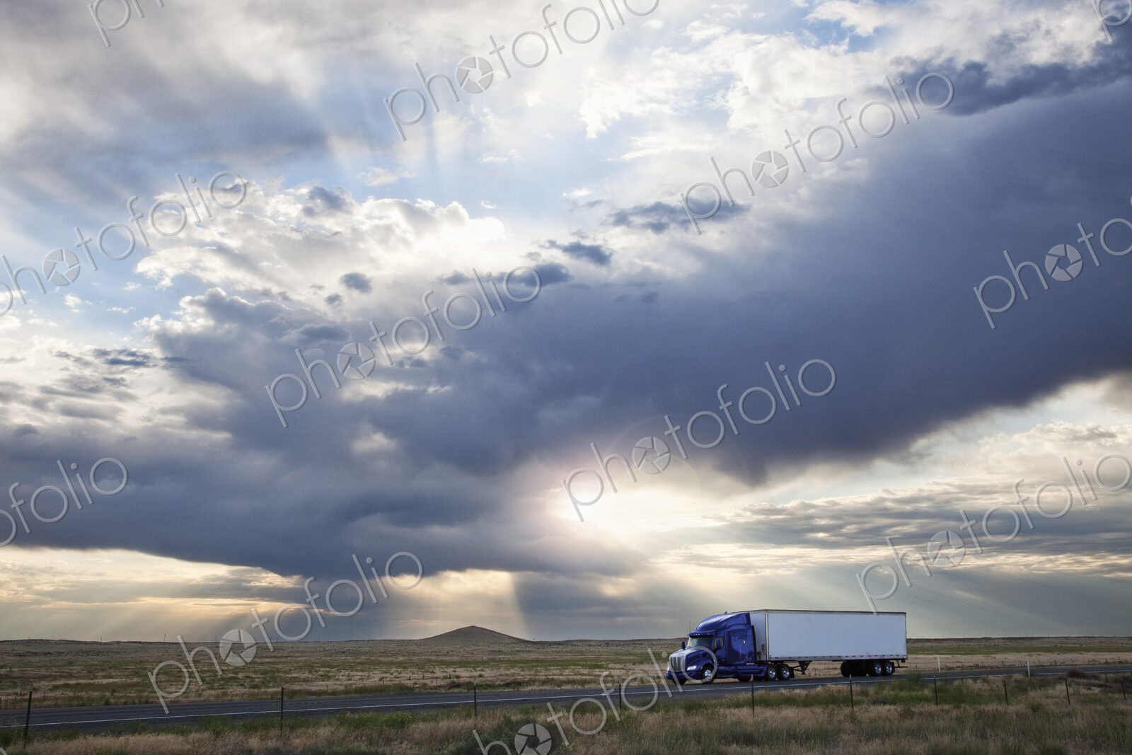 Commercial truck driving through the high desert country of eastern Washington, USA