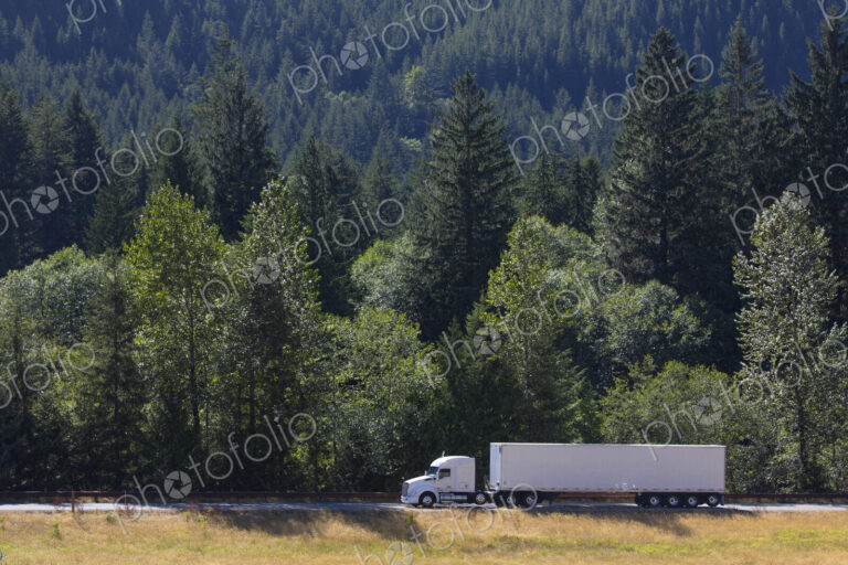 Commercial truck on a highway in the mountains east of Seattle, Washington USA