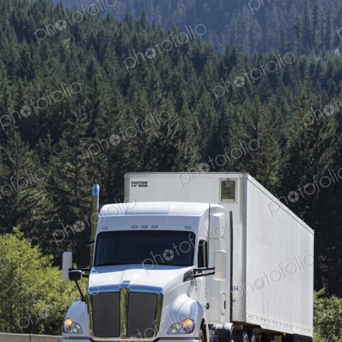 Commercial truck on a highway in the mountains east of Seattle, Washington USA