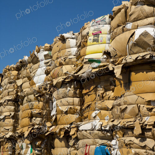 Commercial waste management, bales of recycling materials, cardboard stacked up. Commercial waste management, bales of recycling materials, cardboard stacked up.