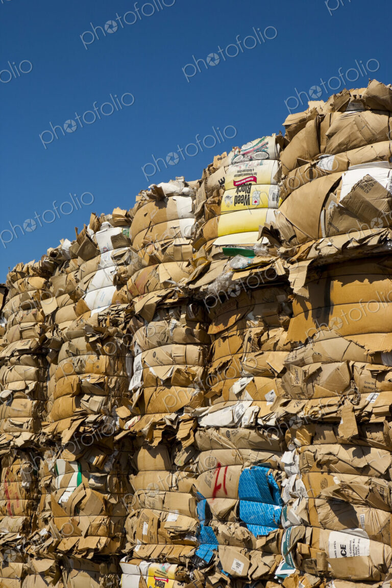 Commercial waste management, bales of recycling materials, cardboard stacked up.