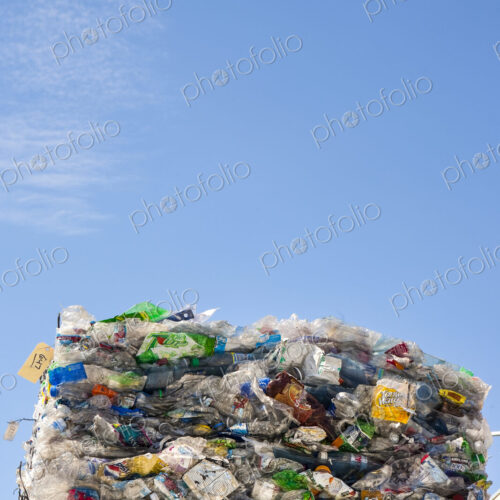 Commercial waste management, bales of recycling materials, plastics stacked up.