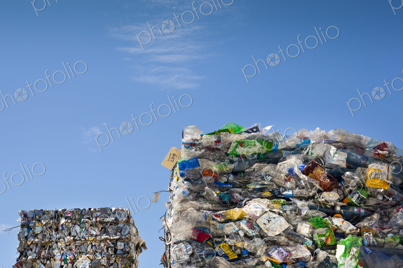 Commercial waste management, bales of recycling materials, plastics stacked up.