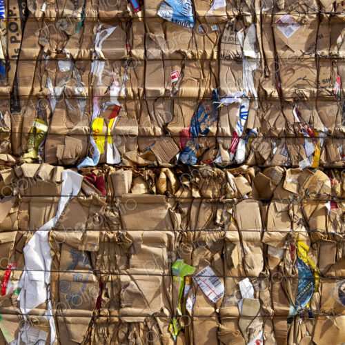 Compacted compressed cardboard for recycling, a central collection point for…
