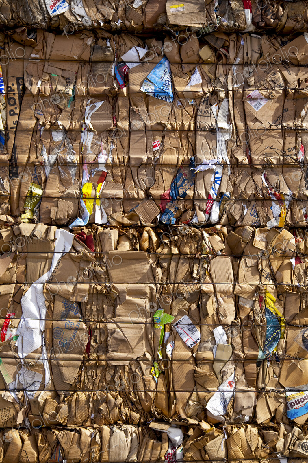 Compacted compressed cardboard for recycling, a central collection point for…