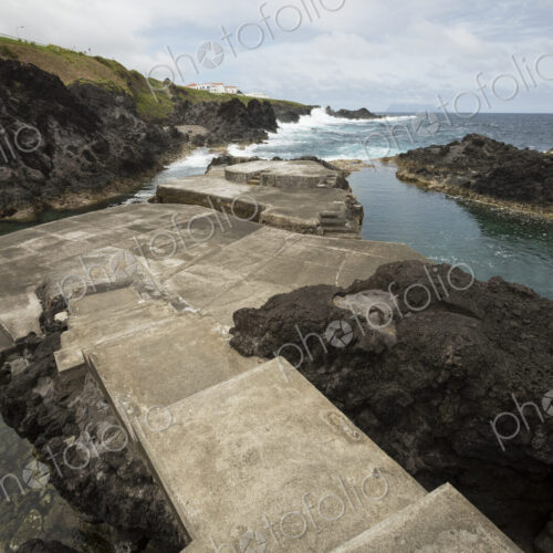 Concrete path to public swimming pool near ocean