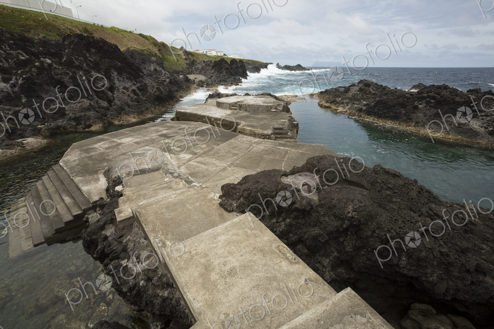 Concrete path to public swimming pool near ocean