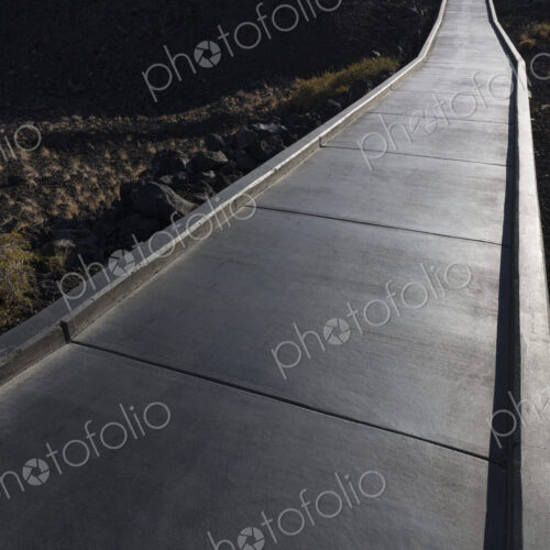 Concrete walkway extends through lava filed, Craters of the Moon National Monument,… Concrete walkway extends through lava filed, Craters of the Moon National Monument,…
