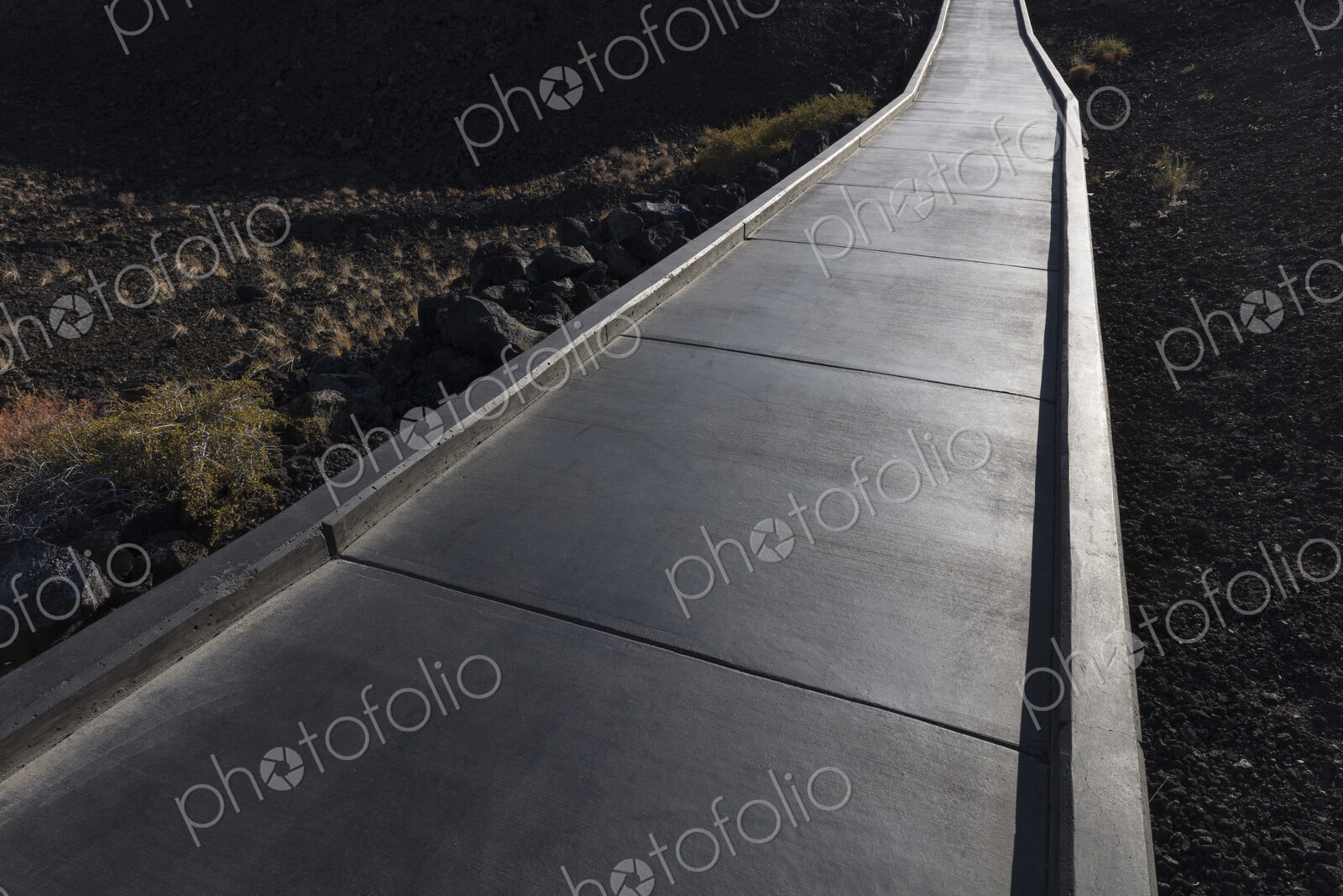 Concrete walkway extends through lava filed, Craters of the Moon National Monument,…