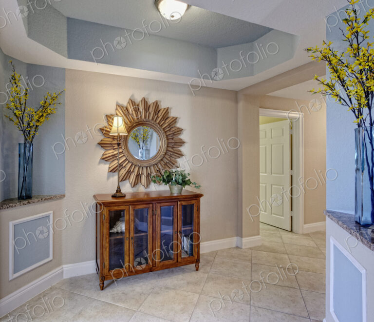 Condominium Interior, a hallway with display cabinet and sunburst style mirror, vases…