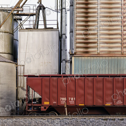 Container on train tracks in industrial train yard