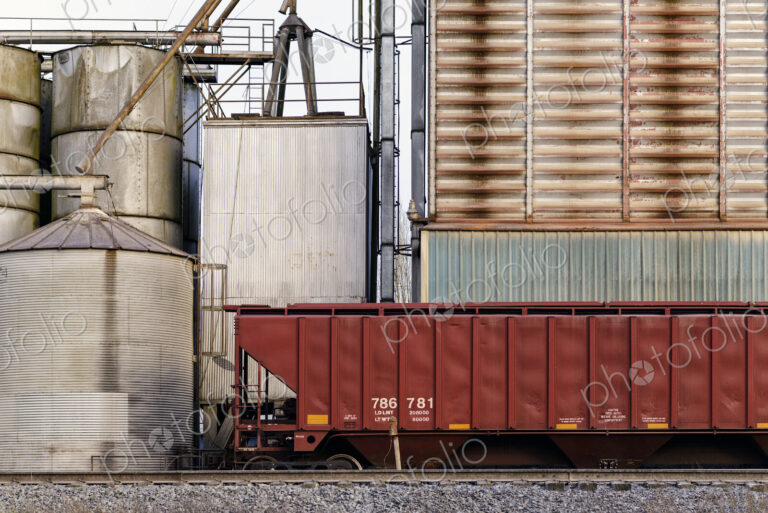 Container on train tracks in industrial train yard