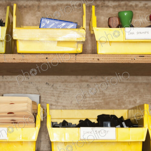 Containers with stationery on shelves.