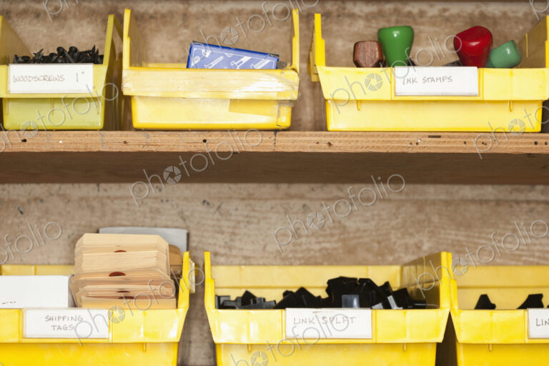 Containers with stationery on shelves.