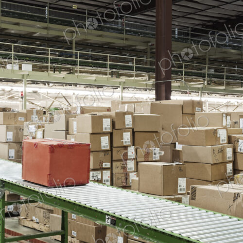 Conveyor belt sytem and cardboard boxes of products in a distribution warehouse.