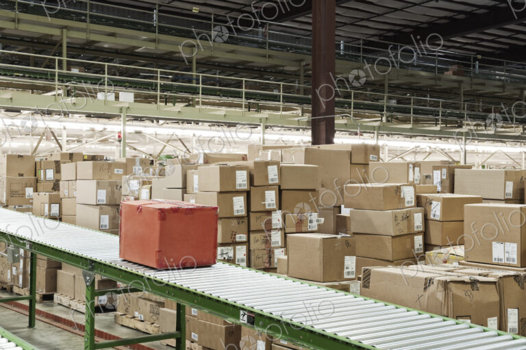 Conveyor belt sytem and cardboard boxes of products in a distribution warehouse.