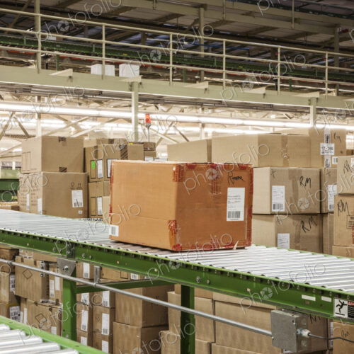 Conveyor belt sytem and cardboard boxes of products in a distribution warehouse. Conveyor belt sytem and cardboard boxes of products in a distribution warehouse.