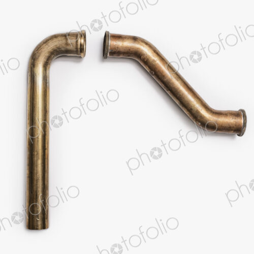Copper Plumbing Pipe Sections. Two pieces of copper pipe. Shiny formed shaped pieces. Copper Plumbing Pipe Sections. Two pieces of copper pipe. Shiny formed shaped pieces.