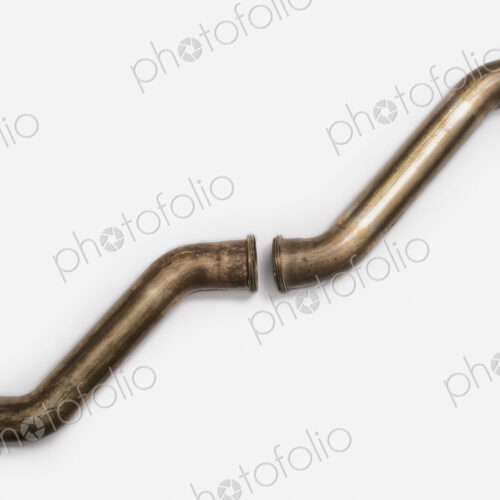 Copper Plumbing Pipe Sections. Two pieces of copper pipe. Shiny formed shaped pieces. Copper Plumbing Pipe Sections. Two pieces of copper pipe. Shiny formed shaped pieces.