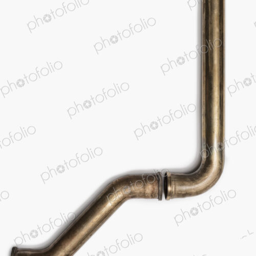 Copper Plumbing Pipe Sections. Two pieces of copper pipe. Shiny formed shaped pieces.