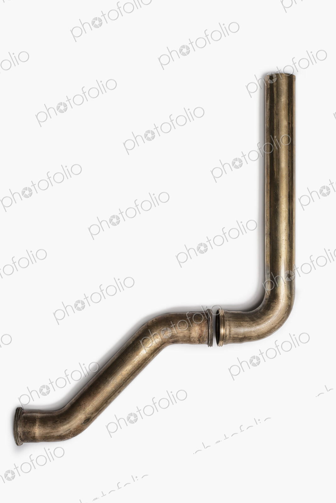 Copper Plumbing Pipe Sections. Two pieces of copper pipe. Shiny formed shaped pieces.