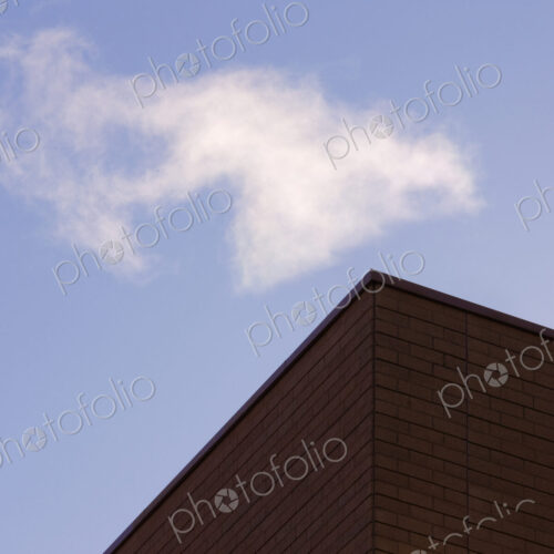 Corner of a building with blue sky beyond.