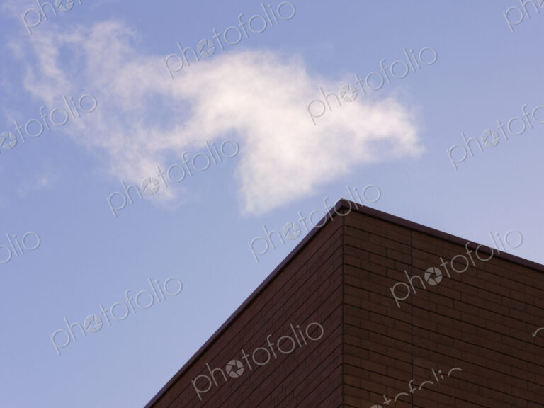 Corner of a building with blue sky beyond.