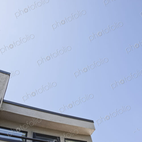 Corner of apartment building and balcony with blue sky. Corner of apartment building and balcony with blue sky.