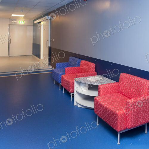 Corridor and waiting areas of a modern hospital with seating Corridor and waiting areas of a modern hospital with seating