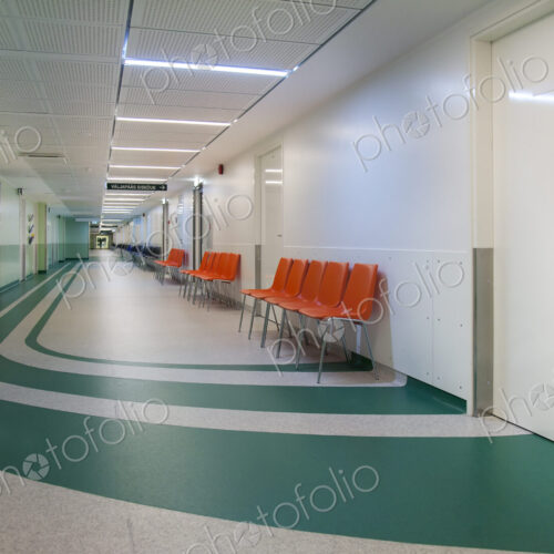 Corridor and waiting areas of a modern hospital with seating Corridor and waiting areas of a modern hospital with seating