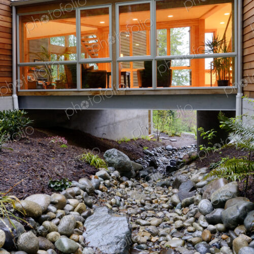 Corridor of modern house built over rocky creek Corridor of modern house built over rocky creek