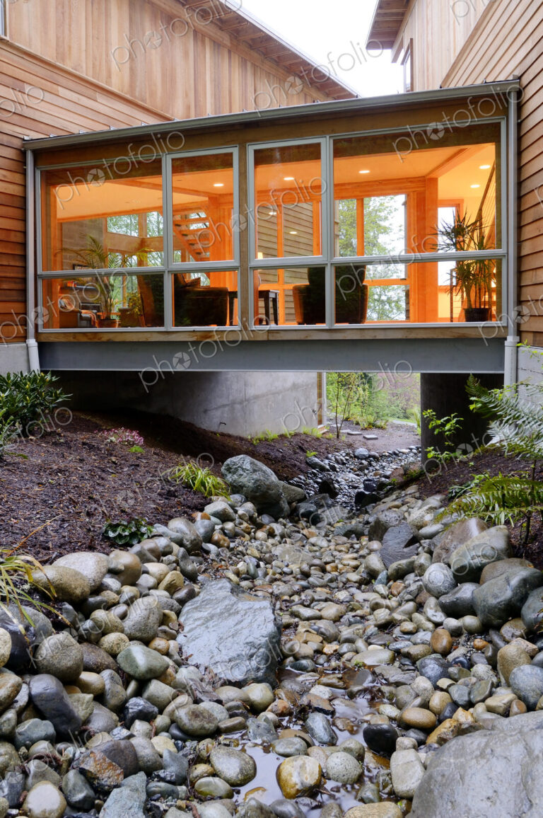 Corridor of modern house built over rocky creek