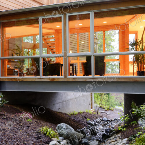 Corridor of modern house built over rocky creek Corridor of modern house built over rocky creek
