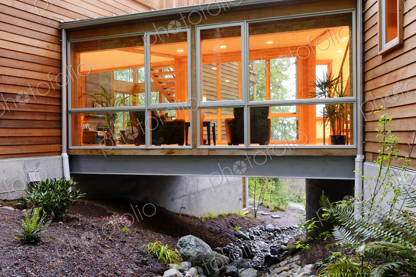 Corridor of modern house built over rocky creek