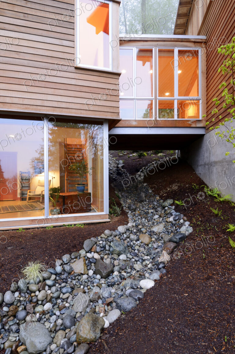 Corridor of modern house built over rocky creek