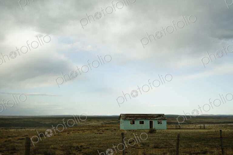 Cottage in rural landscape.