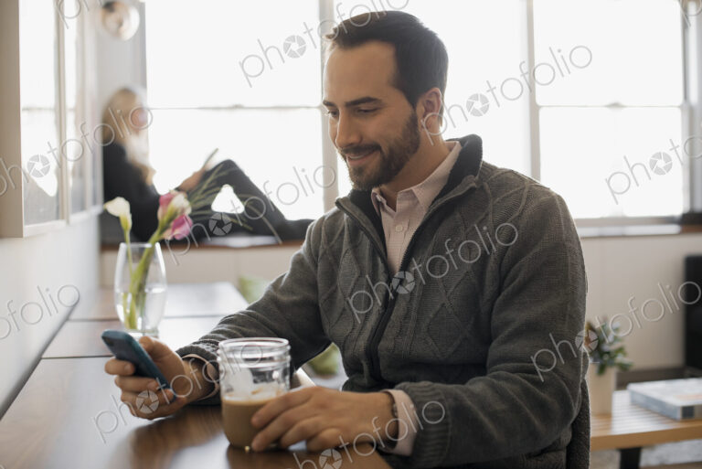 Couple Relaxing at Home with Laptop and E-Reader