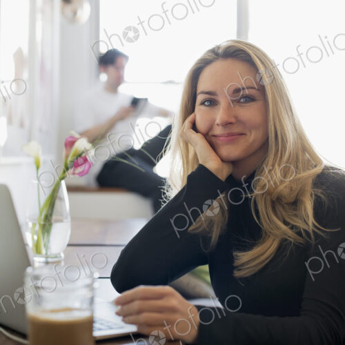 Couple at Home, Woman using Laptop and Man using Tablet Couple at Home, Woman using Laptop and Man using Tablet
