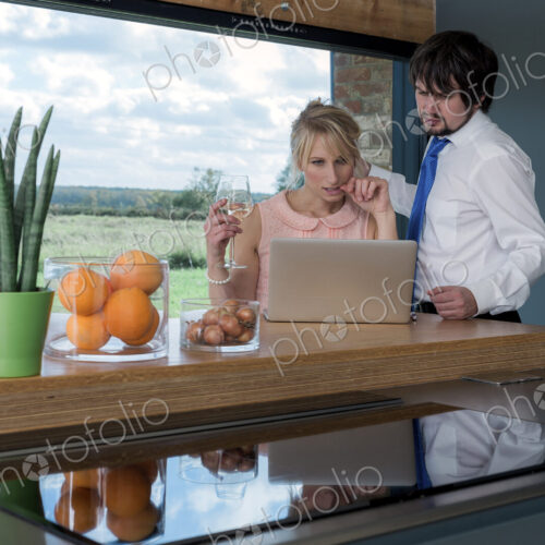 Couple at breakfast looking at a laptop together. Couple at breakfast looking at a laptop together.