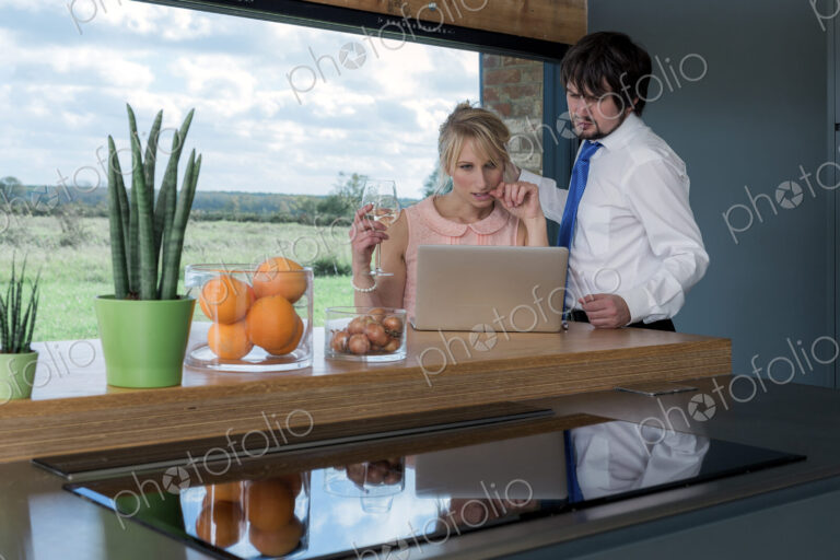 Couple at breakfast looking at a laptop together.