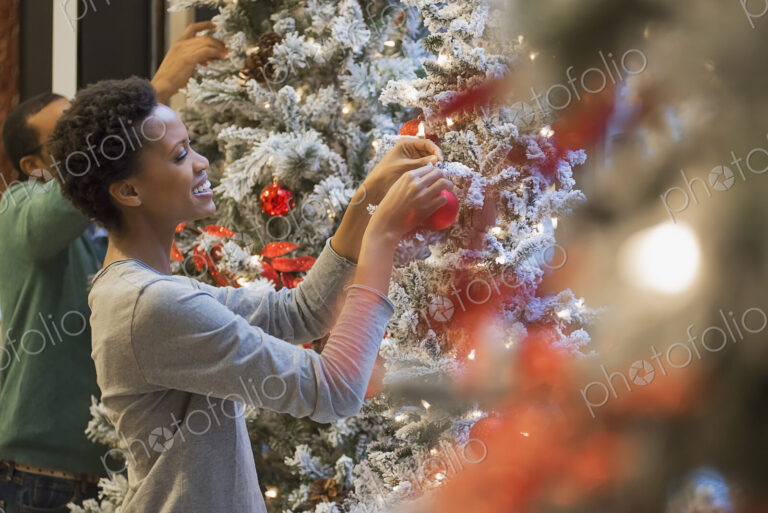 Couple at home decorating for Holidays