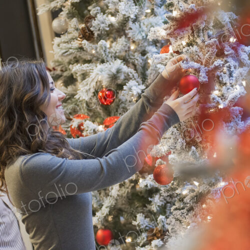 Couple at home decorating for Holidays