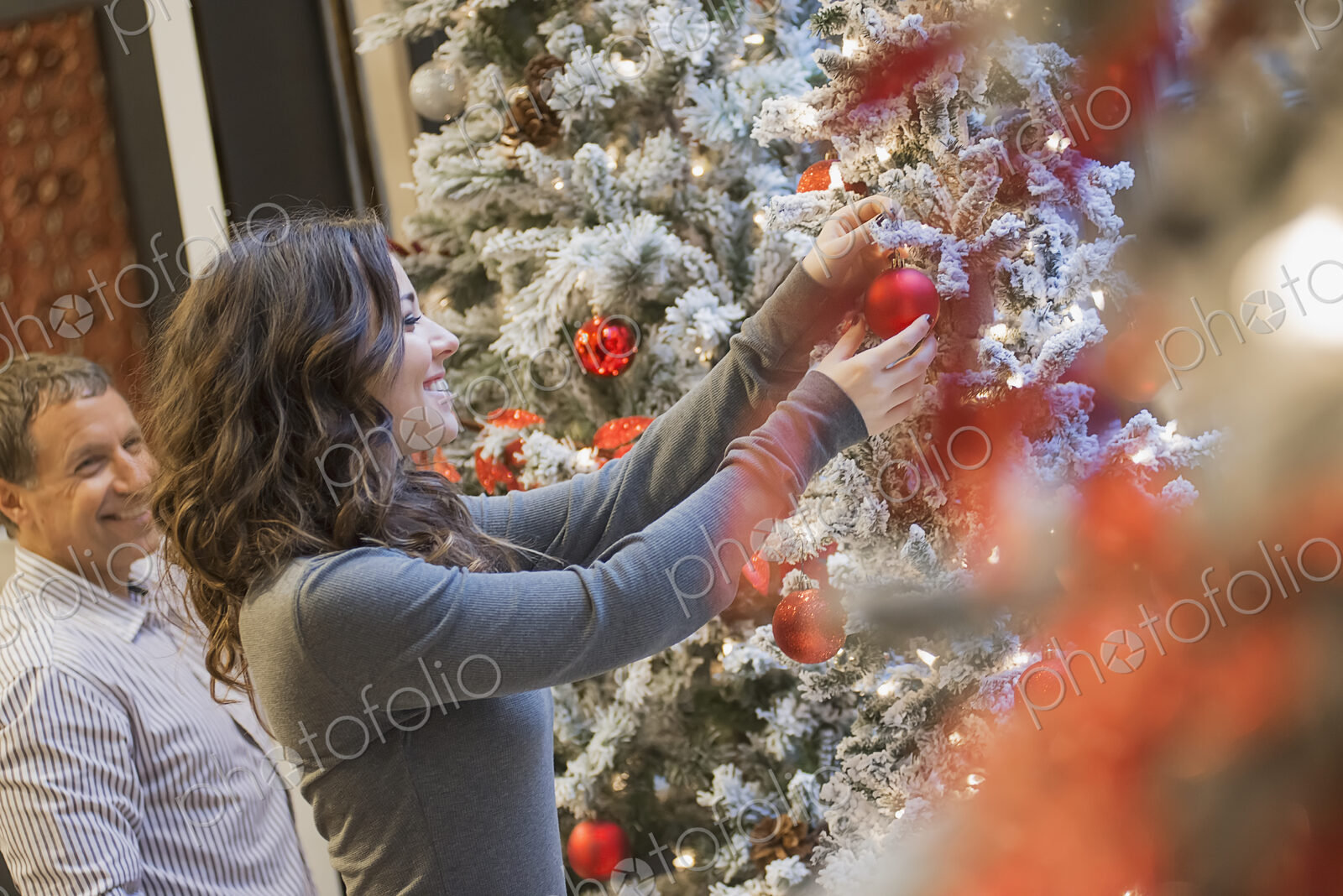 Couple at home decorating for Holidays