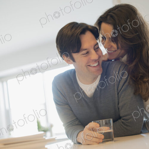 Couple connecting at home in kitchen Couple connecting at home in kitchen