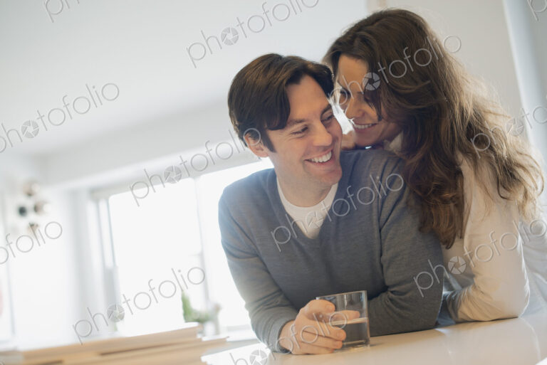 Couple connecting at home in kitchen
